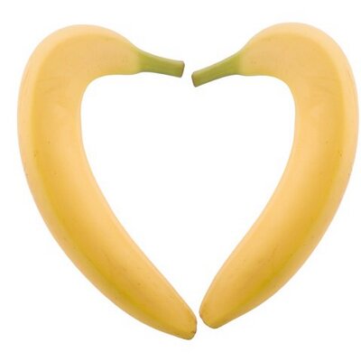 two bananas in shape of heart on white background